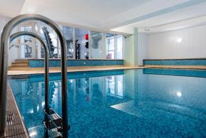 a swimming pool with blue tiles in a building at Royal Glen Hotel in Sidmouth