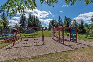 a playground in a park with two swings at Trysil Hyttegrend in Trysil