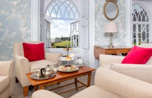 a living room with two chairs and a table at Royal Glen Hotel in Sidmouth