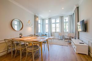 a dining room with a table and chairs at Grand Apartments - Lighthouse 200 meters from the beach in Sopot