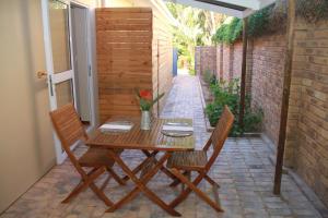 a wooden table and chairs on a patio at The Vine in Klawer