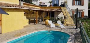 a house with a swimming pool next to a building at Soleillas in Vence