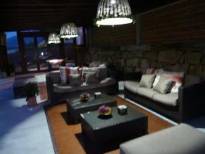 a living room with couches and tables and chandeliers at POSADA El ABUELO DE LA CACHAVA in Gajano