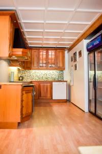 a kitchen with wooden cabinets and a white refrigerator at Trolltunga/Folgefonna Camp house in Jondal