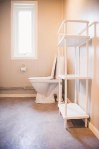 a bathroom with a white toilet and a window at Trolltunga/Folgefonna Camp house in Jondal +32 photos