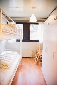 a bedroom with two bunk beds and a table at Trolltunga/Folgefonna Camp house in Jondal