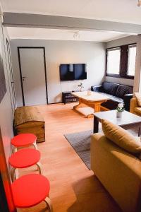a living room with a couch and a table at Trolltunga/Folgefonna Camp house in Jondal