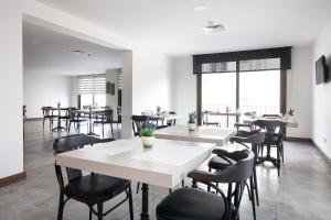 a dining room with tables and chairs and windows at Lavanta Residence in Kyrenia