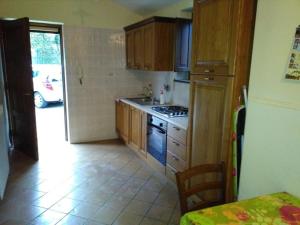 a kitchen with a sink and a stove top oven at DOMINO HOUSE - Il Casale in Sorrento