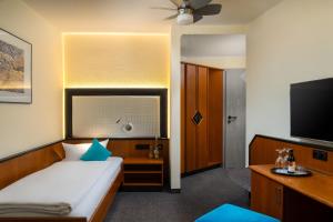 Letto o letti in una camera di Hetzel Hotel Stuttgart