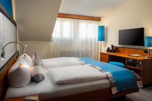 Letto o letti in una camera di Hetzel Hotel Stuttgart