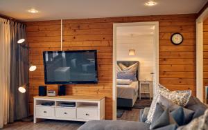 a living room with a television and a bedroom at Place2be in Grafenau