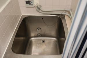 a metal sink in a bathroom with a hose at Apartment Namba Daikoku in Osaka +78 photos