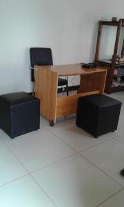 a wooden desk with two chairs and a mirror at The Star B&B in Jwaneng