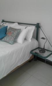 a bed with a lamp on a glass table at The Star B&B in Jwaneng