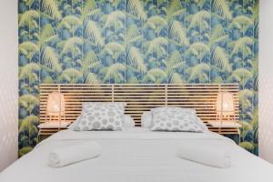 a bedroom with a bed with a blue and green wallpaper at Loft Design for 8 people in Heart of Paris in Paris