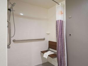 a bathroom with a shower and a toilet at La Quinta by Wyndham Baltimore BWI Airport in Linthicum Heights