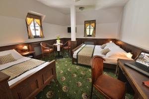 A bed or beds in a room at Hotel Podhrad