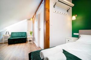 sypialnia z zielonym akcentem, łóżkiem i krzesłem w obiekcie Apartment Zamojska 8 - Apartamenty GKM Lublin w mieście Lublin