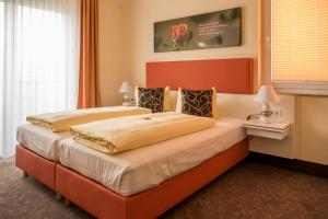 Postel nebo postele na pokoji v ubytování Hotel Sonnengarten