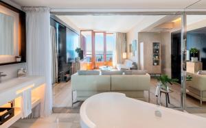
a living room filled with furniture and a large window at Hotel de Mar Gran Meliá - Adults Only - The Leading Hotels of the World in Illetas
