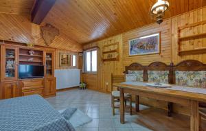 a dining room with a table and a tv at Cottage Nilda I in Poreč