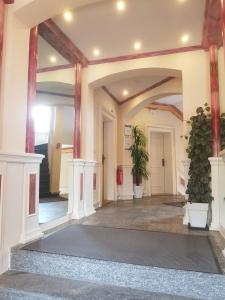 a lobby with two potted plants in a building at Pension Giesserstrasse Leipzig in Leipzig