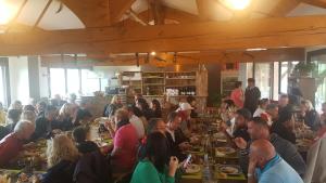 a group of people sitting at tables in a restaurant at U San Larenzu in Aullène