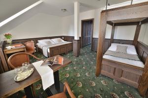 A bed or beds in a room at Hotel Podhrad