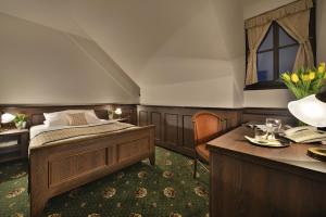 A bed or beds in a room at Hotel Podhrad