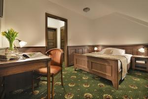 A bed or beds in a room at Hotel Podhrad