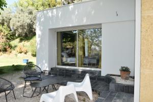 a home with a large window and chairs at suite indépendante au calme avec piscine in Aix-en-Provence