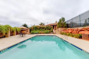 a swimming pool with blue water in a yard at 2 Bed 2 Bath Vacation home in Sedona in Sedona
