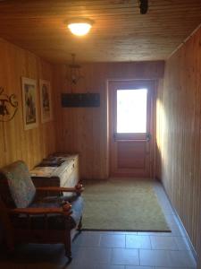 a room with a door and a chair and a window at Hotel Camping Grivola in Valsavarenche