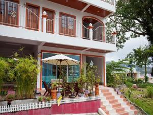 a house with a patio with an umbrella at Grand View in Patong Beach