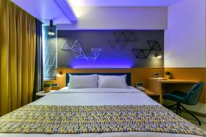 a bedroom with a large bed with a purple wall at Indie Stays in Mumbai