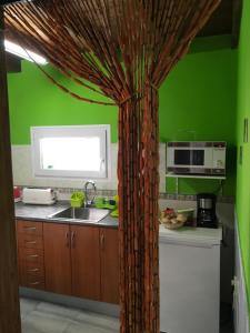 a kitchen with a curtain in the middle of a kitchen at loft patri Caleta de Fuste in Caleta De Fuste