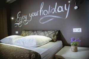 Postel nebo postele na pokoji v ubytování Gregory Comfort Hotel