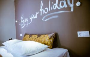 Postel nebo postele na pokoji v ubytování Gregory Comfort Hotel