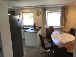 a kitchen with a table and a kitchen with a table and chairs at Apartment Ereiz in Hermagor