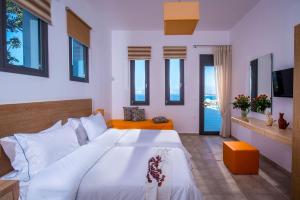 a bedroom with a large white bed and windows at Villa Bellelen in Agios Nikolaos +25 photos