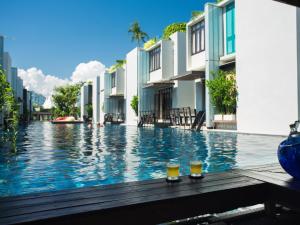 a large pool of water next to a large building at Let's Sea Hua Hin Al Fresco Resort in Hua Hin