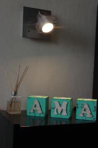 a table with three green boxes with letters on it at Villa Cabrera Apart and Suites in Cordoba