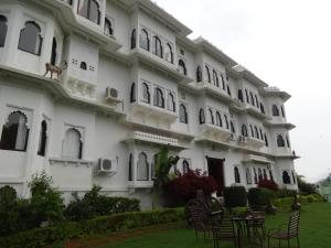 a large white building with chairs in front of it at Karohi Haveli - A Heritage Hotel in Udaipur