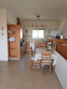 a kitchen with a table and chairs in a room at Bertha's Coffee in Afula