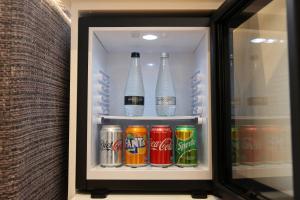 a refrigerator filled with lots of different types of drinks at Latimer House in Bowness-on-Windermere