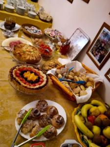 a table with many different types of food on it at Hotel Casa Mia in Syracuse