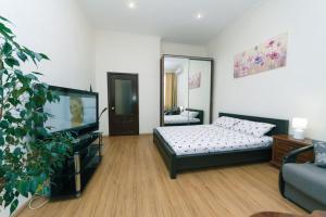 a living room with a bed and a couch at Apartment on Saksahanskoho Street in Kyiv