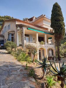 a house with a lot of plants in front of it at Villa La Renarde in Le Lavandou