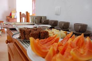 a buffet with several different types of desserts on plates at Villa Maris Ecolodge in Morro